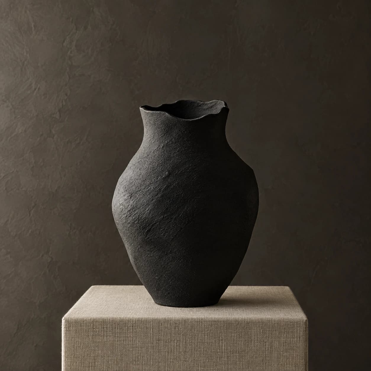 AI product photograph of a hand-thrown matte black ceramic vase on a linen plinth in soft side light.